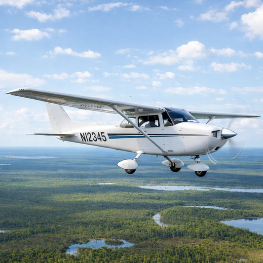 Small airplane flying over a landscape with trees and water bodies. Plane registration number decals clearly visible.